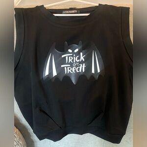 Cute trick or treat crop top.  Large/loose arm holes with fitted waist.